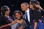 Obama tears up during tribute to Michelle, daughters